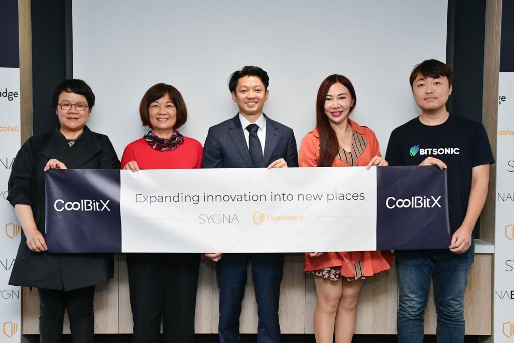 CoolBitX CEO Michael Ou (center) celebrates the Series B funding with his team and new investor Bitsonic's CEO Jinwook Shin